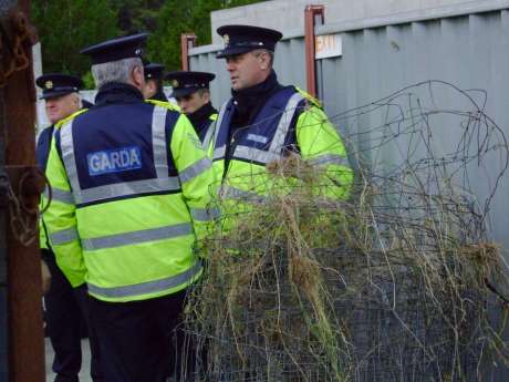 New Belmullet Superintendent John Gilligan (centre) oversees the return of the fencing to Shell at Bellanaboy