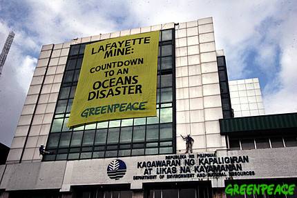 Greenpeace activists unfurl a banner in protest over the conduct of the 30-day test run which the Department of Energy and Natural Resources granted to Australian mining Lafayette last month.  Greenpeace / Alex Baluyut