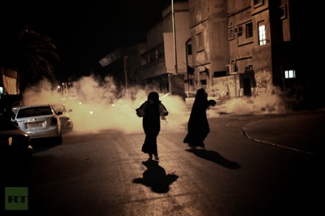 Bahraini women run from tear gas fired by police during an anti-government demonstration in the village of Bani Jamrah, West of Manama, on August 2, 2012 (AFP Photo / Mohammed Al-Shaikh)