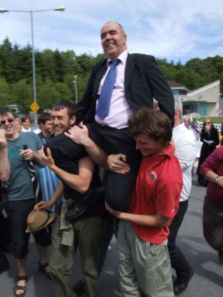 Pat being chaired away from prison