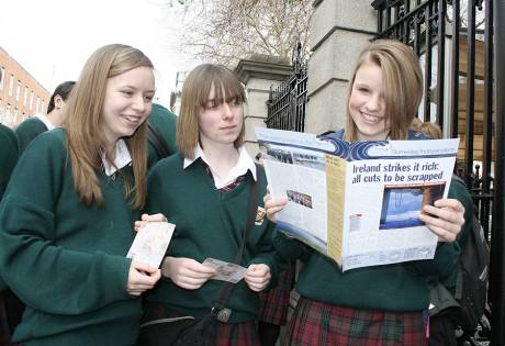 Schoolgirls peruse Shell to Sea's publication, the 'Someday Independent'