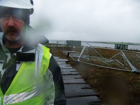 A shell security guard in front of a broken fence