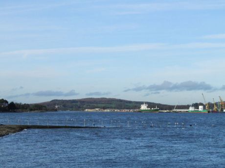 High tide covering Omeath pier with Warrenpoint port in the badkground on the northern side of Carlingford Lough