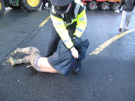 Protester being dragged away from the tractor